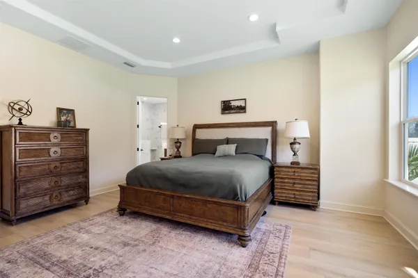 a view of a hallway with wooden floor and cabinet