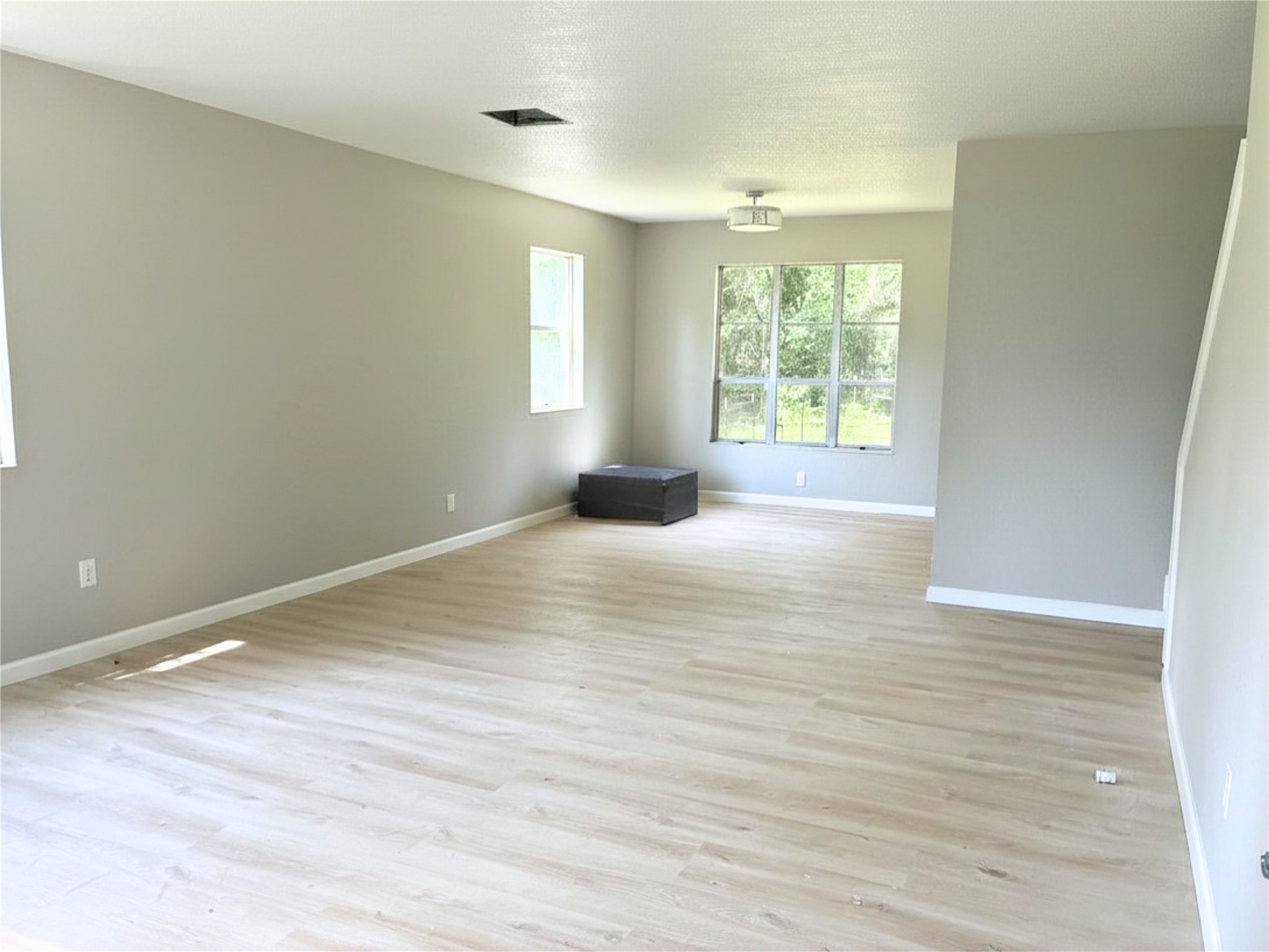117 Amanda Street Conroe, TX 77304 - Photo 7 of 35 a view of empty room with wooden floor and fan
