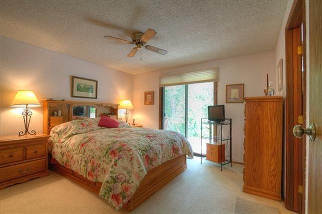 7192 Lower River Road Grants Pass, OR 97526 - Photo 7 of 30 a bedroom with a bed and a chandelier