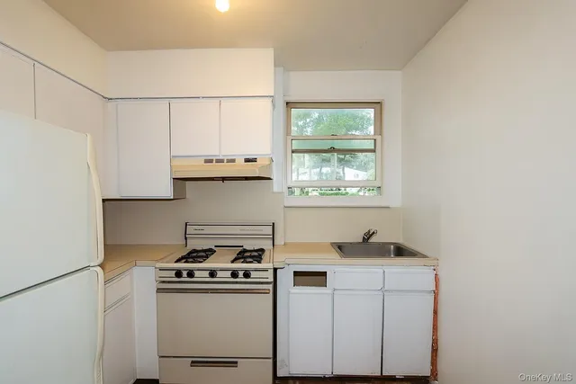 a kitchen with a stove and a refrigerator