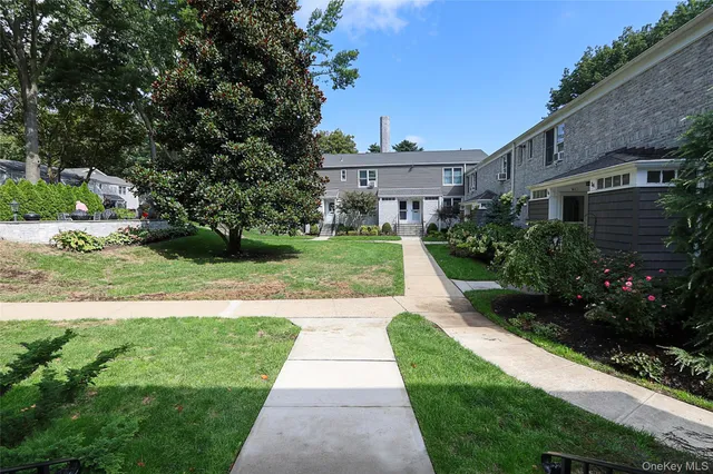 a view of a chair and table and garden in the back yard