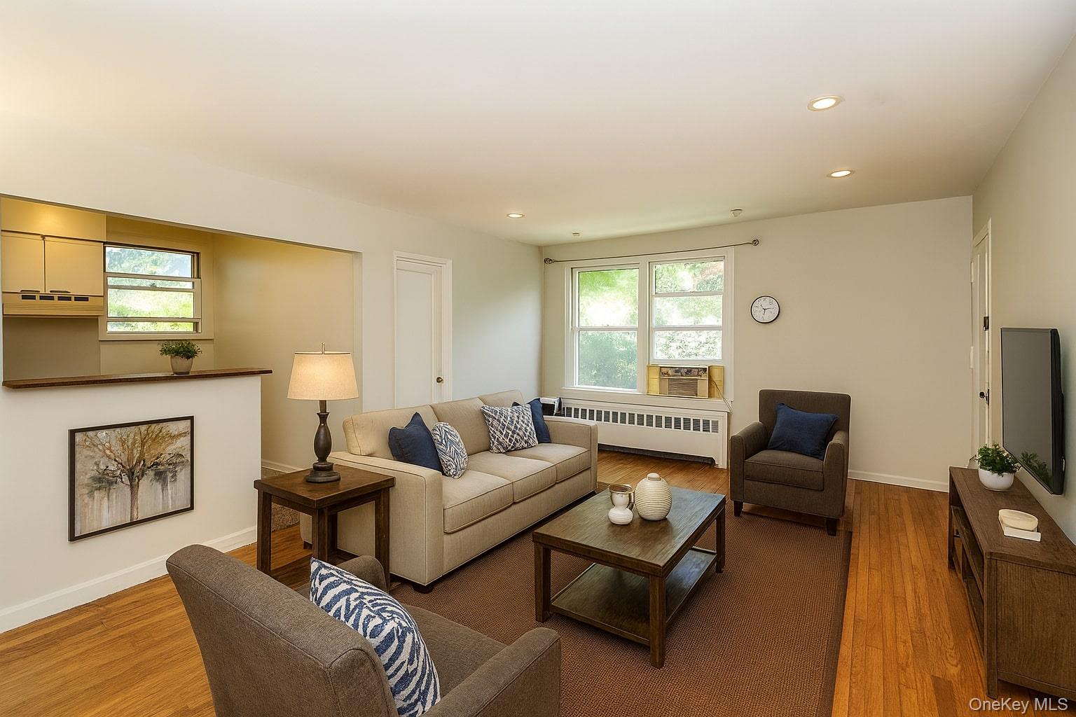 10 Glen Keith Road, Unit U Glen Cove, NY 11542 - Photo 3 of 22 a living room with furniture and a flat screen tv