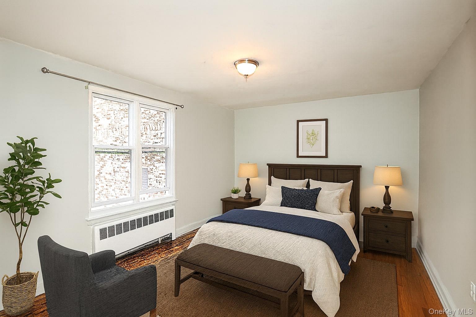 10 Glen Keith Road, Unit U Glen Cove, NY 11542 - Photo 4 of 22 a bedroom with a bed and a window