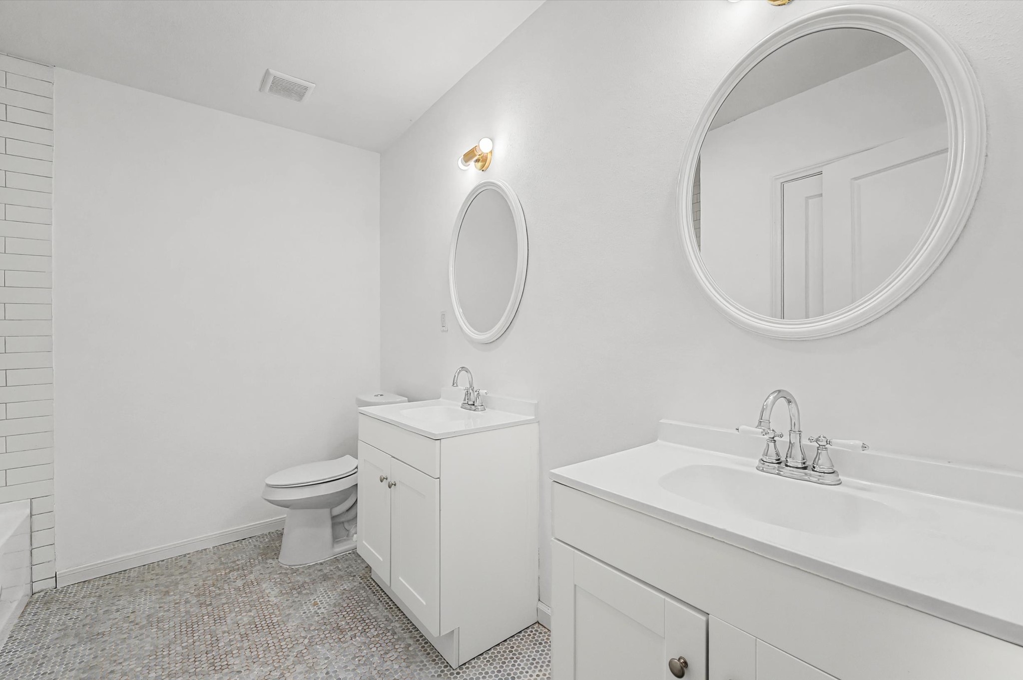 511 Joyce Street Houston, TX 77009 - Photo 12 of 17 a bathroom with a toilet a sink a mirror and vanity