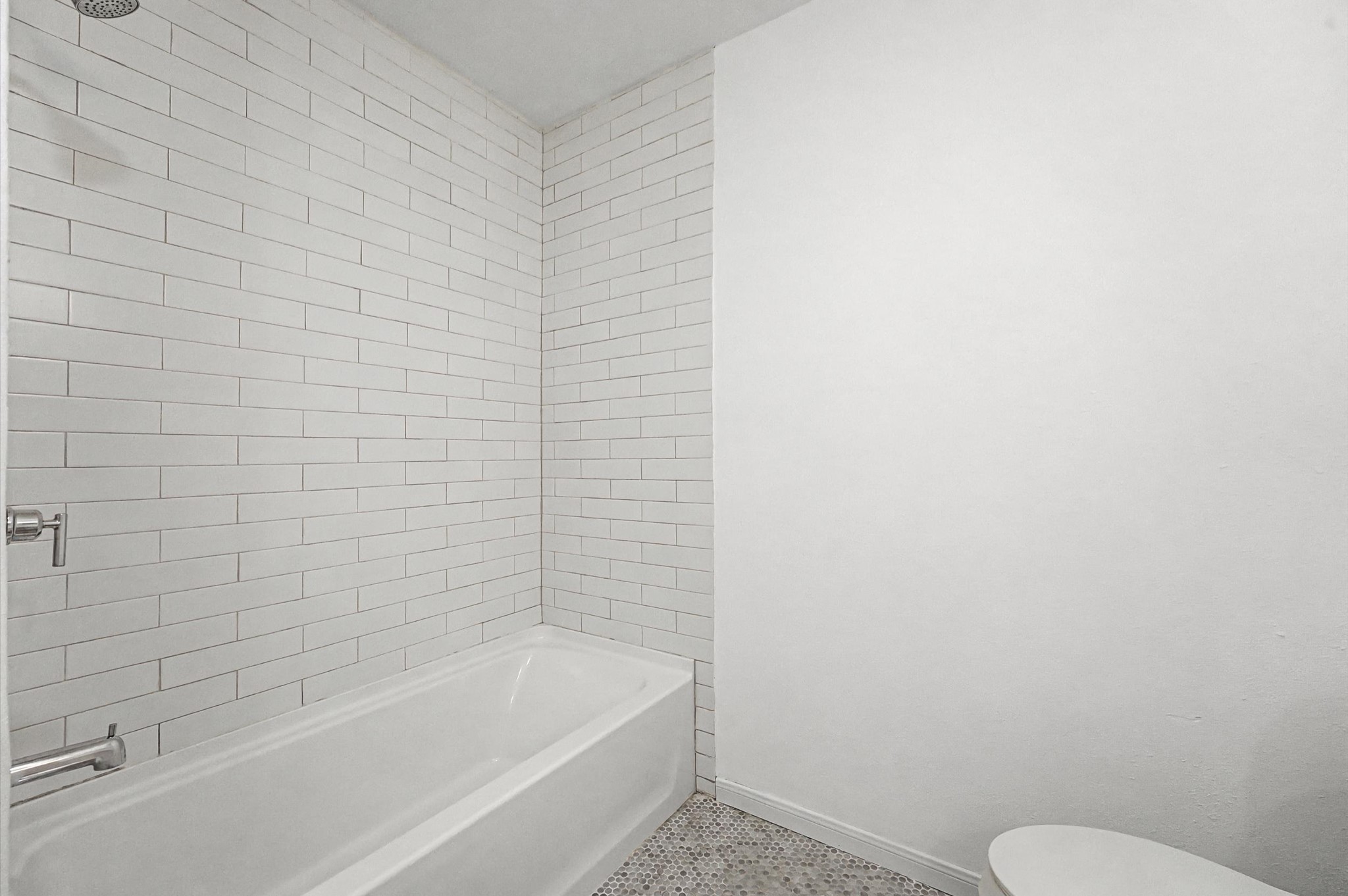 511 Joyce Street Houston, TX 77009 - Photo 13 of 17 a bathroom with a bathtub and toilet