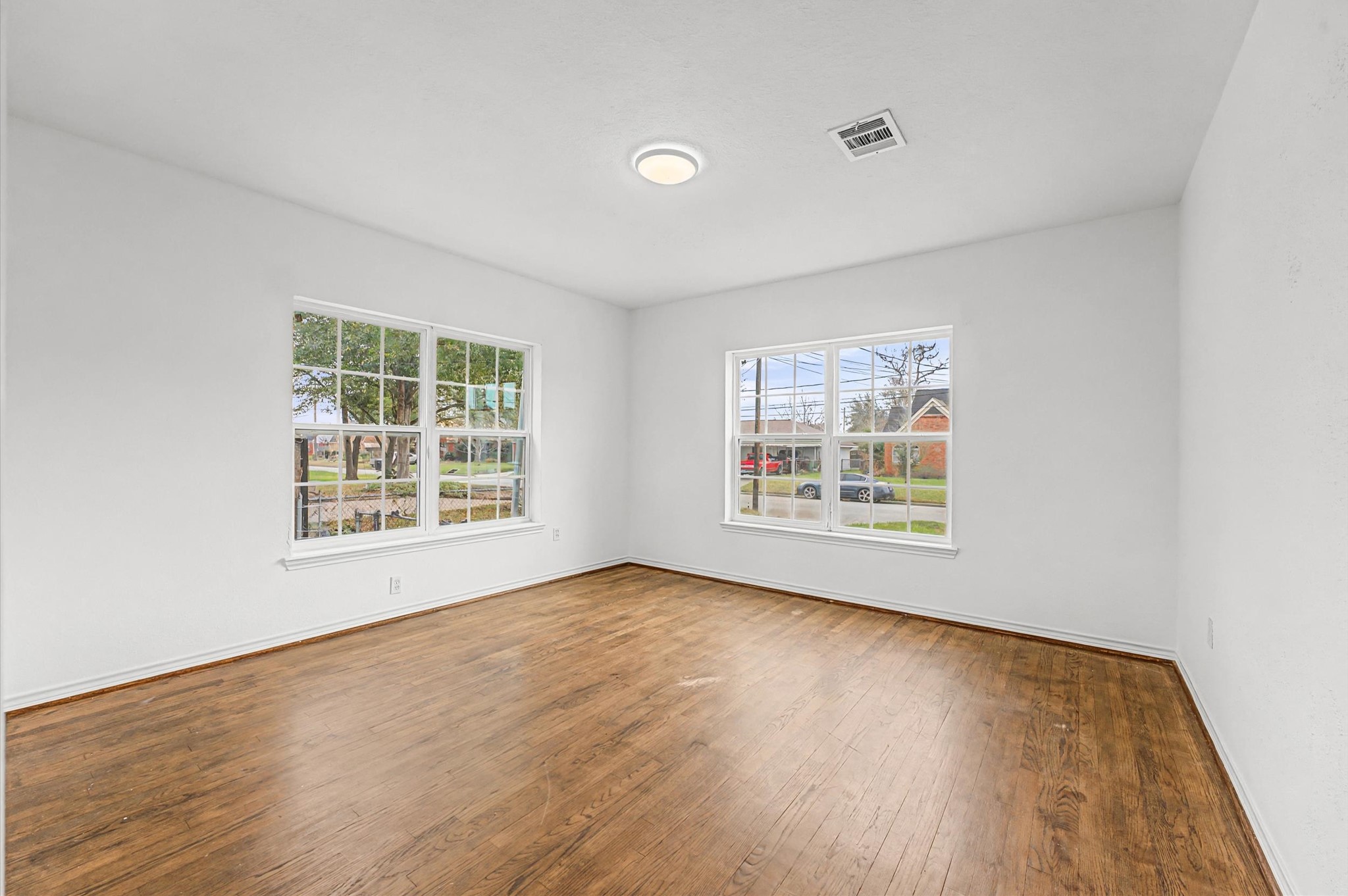511 Joyce Street Houston, TX 77009 - Photo 14 of 17 a view of an empty room with wooden floor and a window
