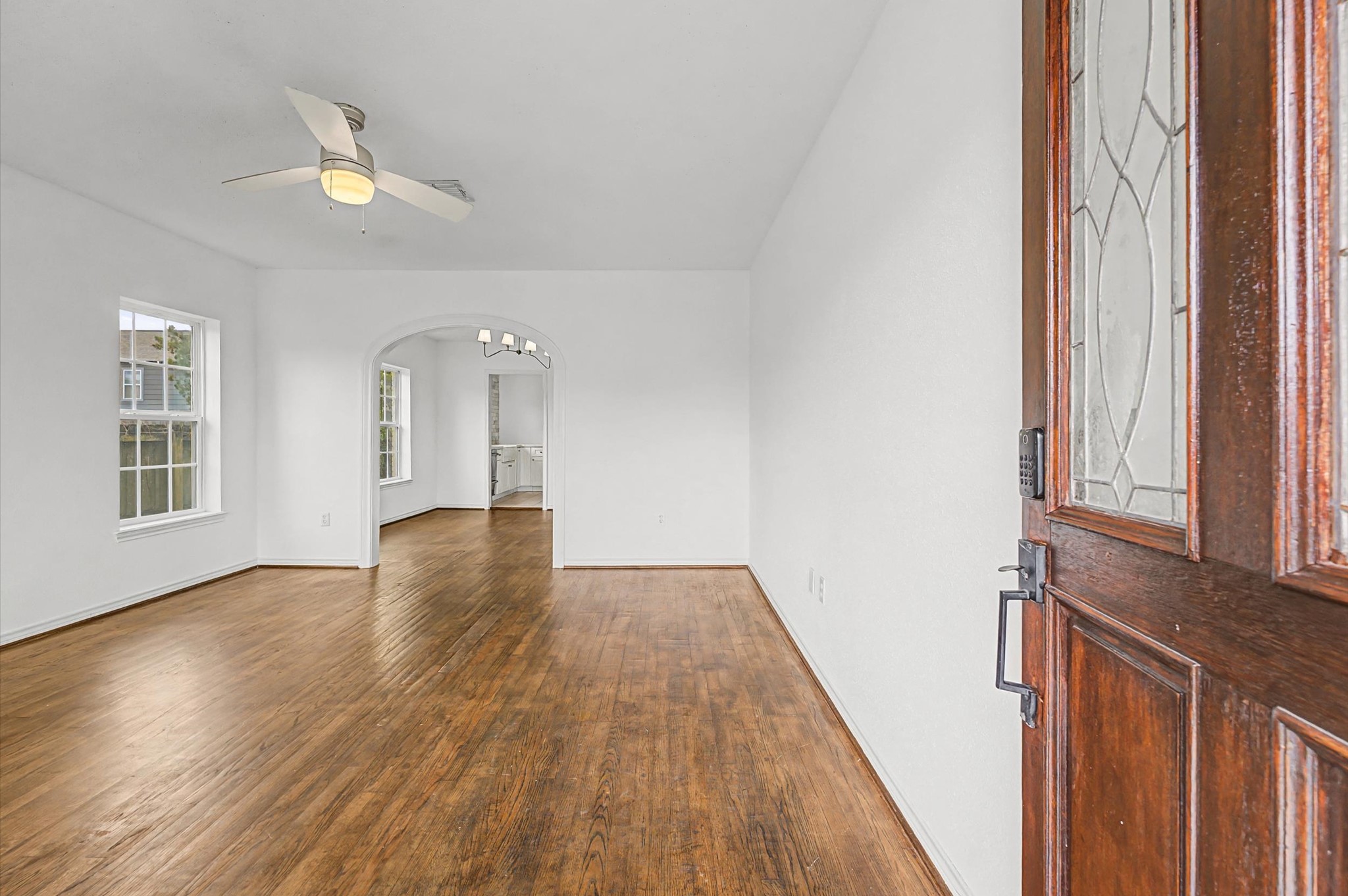 511 Joyce Street Houston, TX 77009 - Photo 3 of 17 a view of an empty room with wooden floor and a window