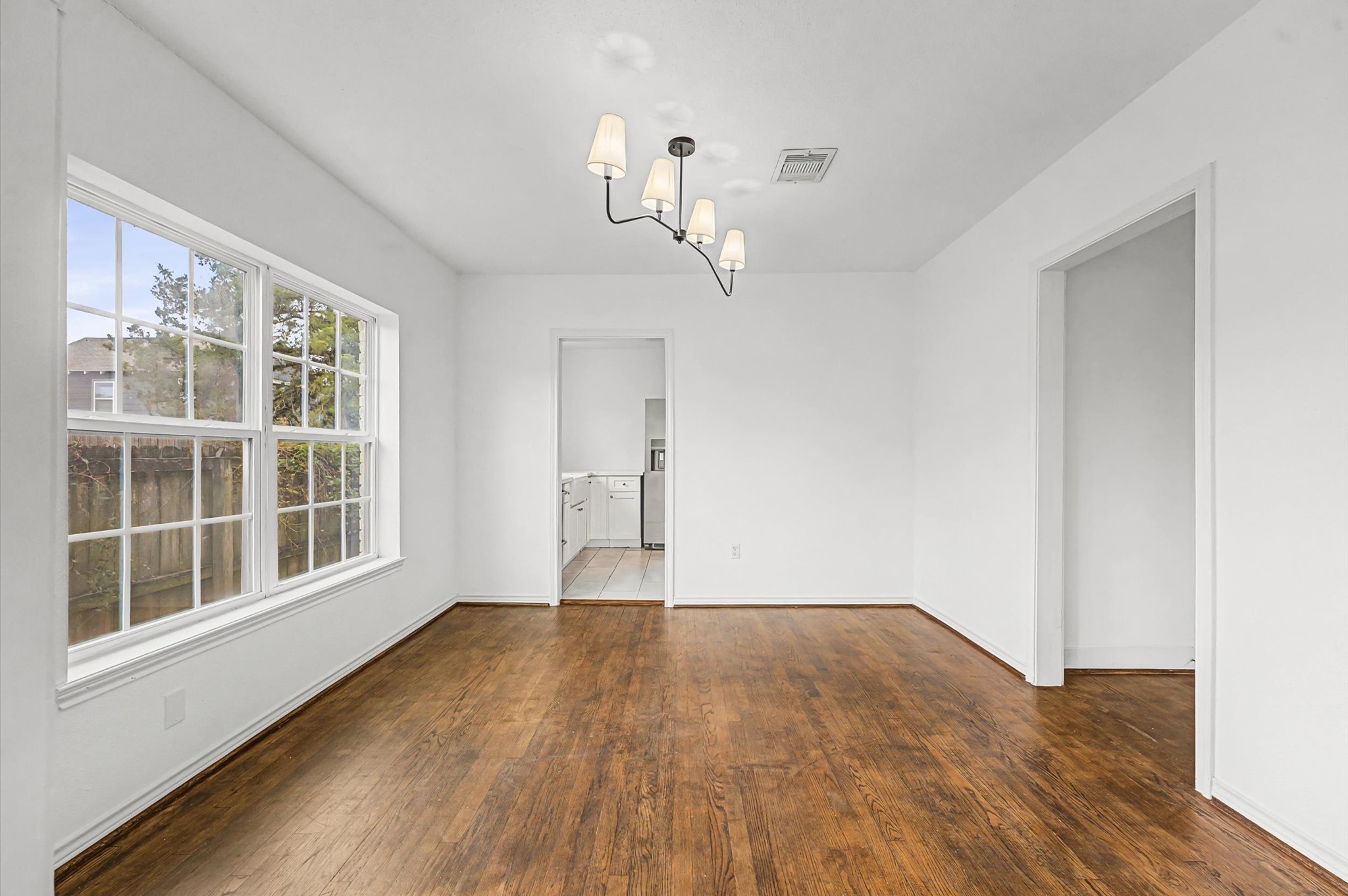 511 Joyce Street Houston, TX 77009 - Photo 6 of 17 a view of empty room with wooden floor and fan