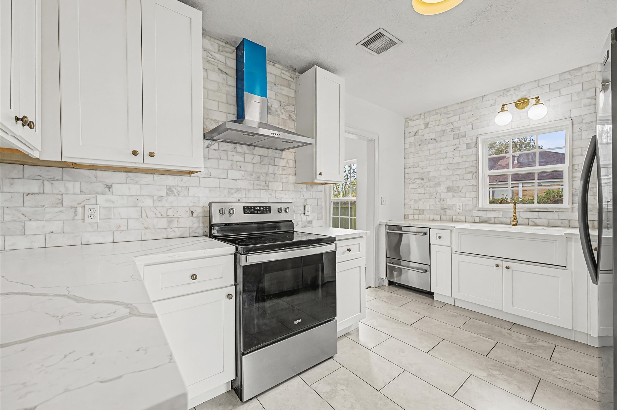 511 Joyce Street Houston, TX 77009 - Photo 7 of 17 a kitchen with granite countertop white cabinets and white appliances