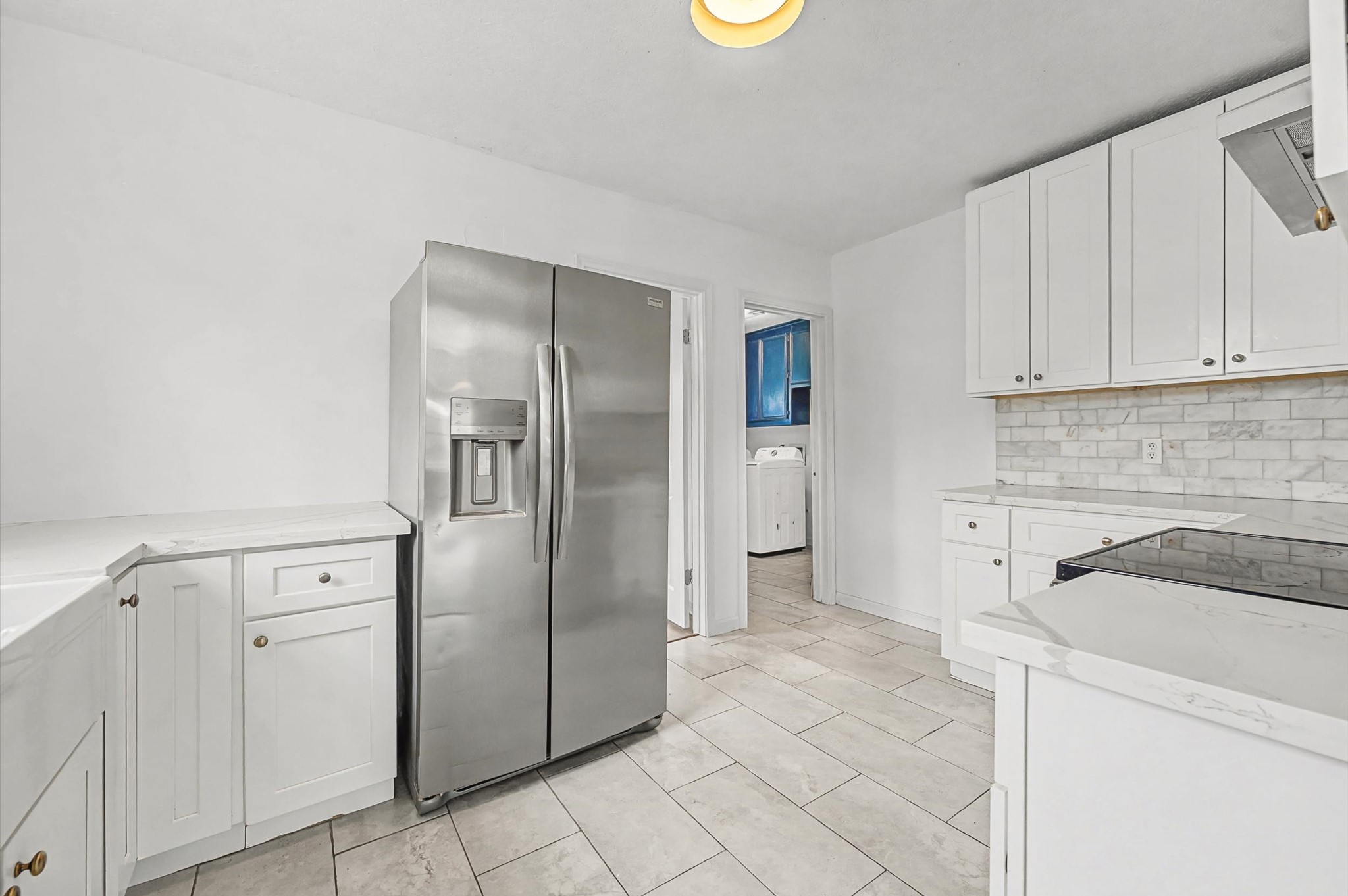 511 Joyce Street Houston, TX 77009 - Photo 8 of 17 a kitchen with a refrigerator and cabinets