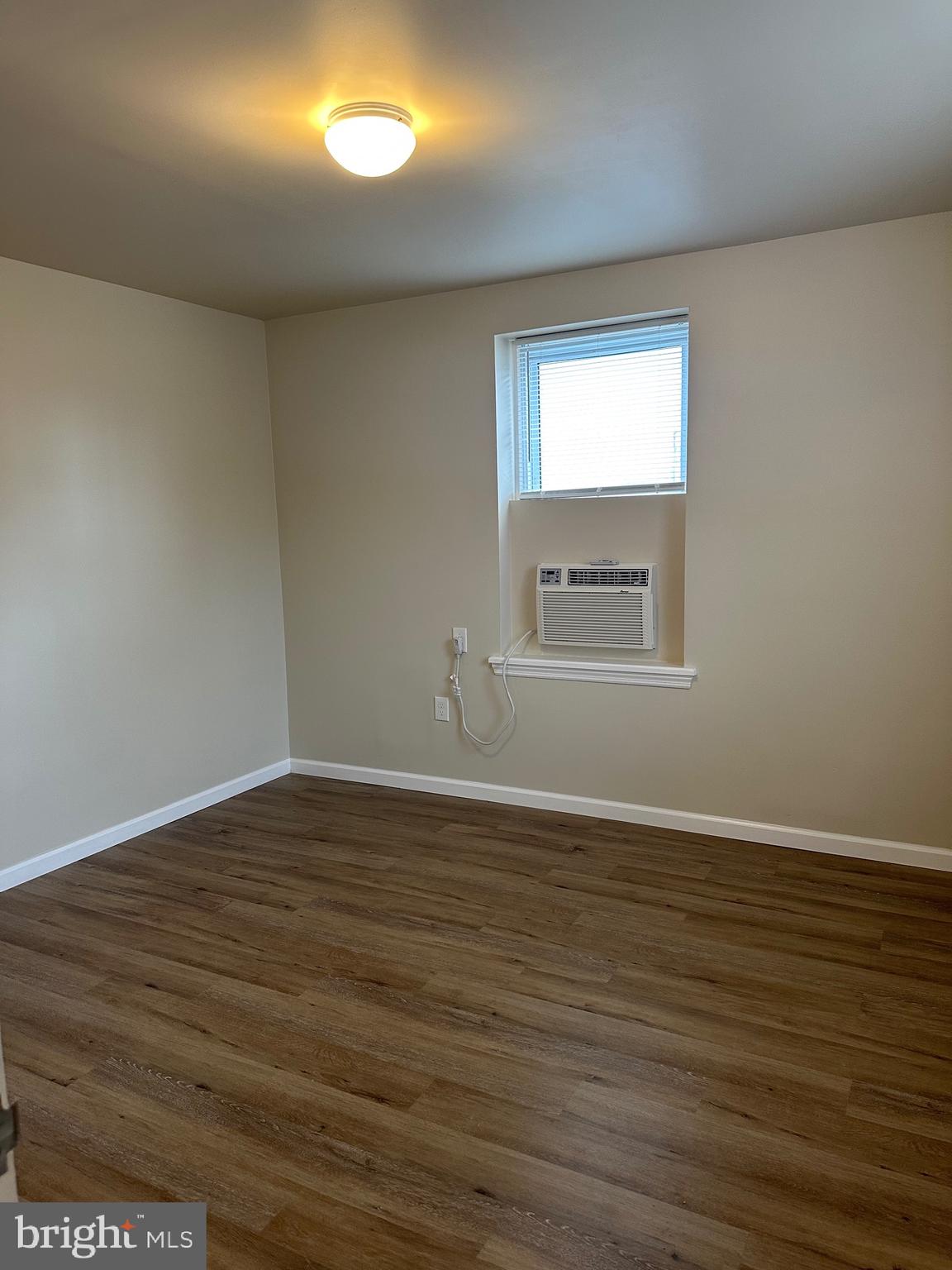 122 East Ridge Road, Unit A4 Marcus Hook, PA 19061 - Photo 11 of 11 a view of an empty room with wooden floor and a window