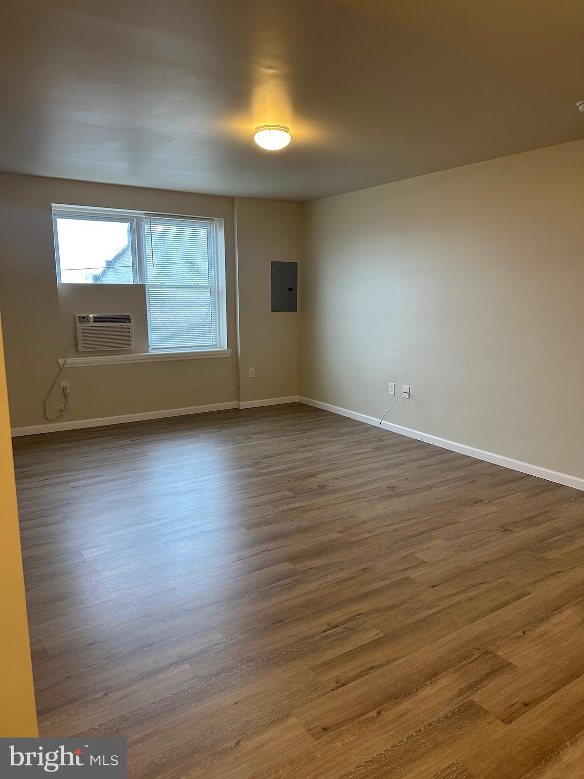 122 East Ridge Road, Unit A4 Marcus Hook, PA 19061 - Photo 3 of 11 an empty room with wooden floor and windows
