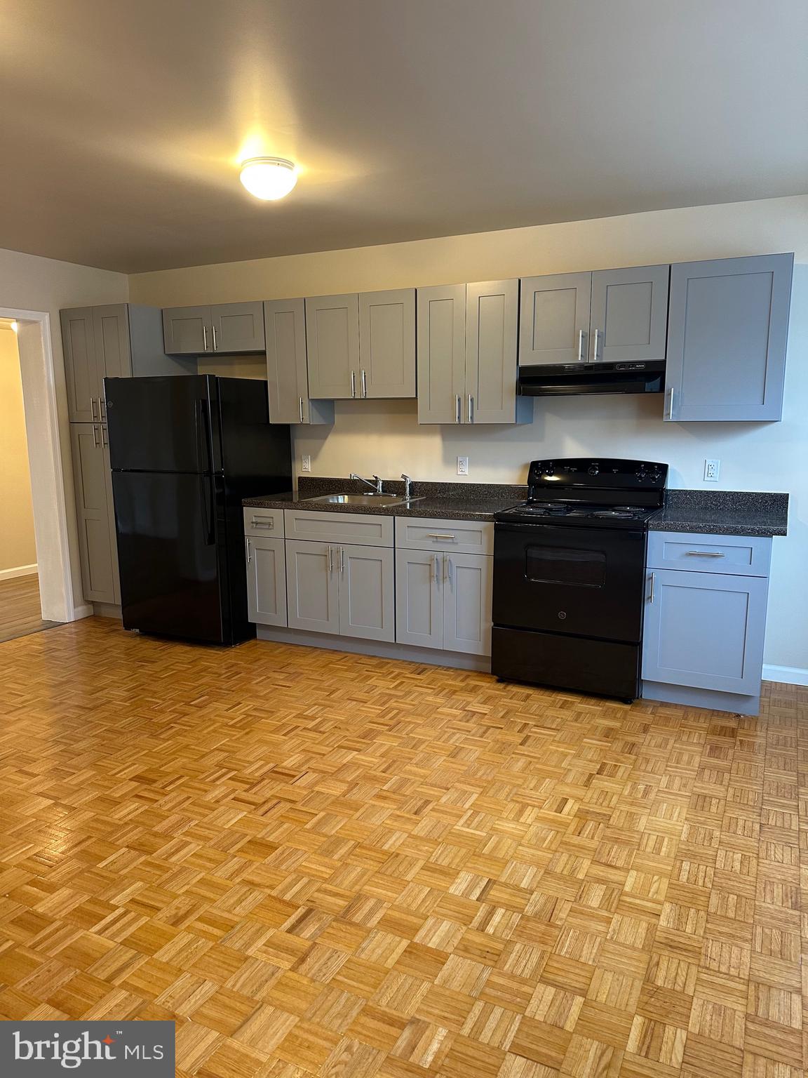 122 East Ridge Road, Unit A4 Marcus Hook, PA 19061 - Photo 6 of 11 a large kitchen with stainless steel appliances granite countertop a refrigerator and a stove top oven