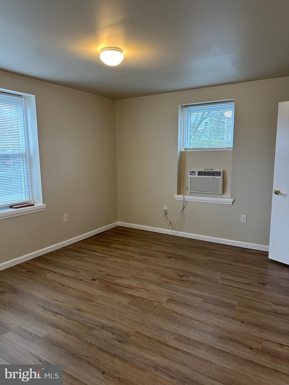122 East Ridge Road, Unit A4 Marcus Hook, PA 19061 - Photo 8 of 11 a view of an empty room with wooden floor and a window