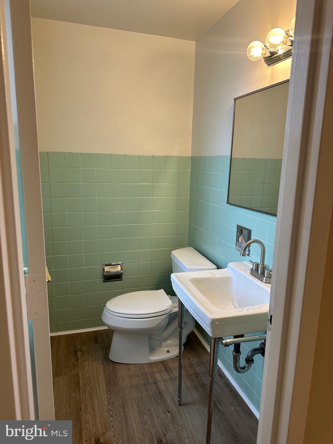122 East Ridge Road, Unit A4 Marcus Hook, PA 19061 - Photo 10 of 11 a bathroom with a toilet a sink and mirror