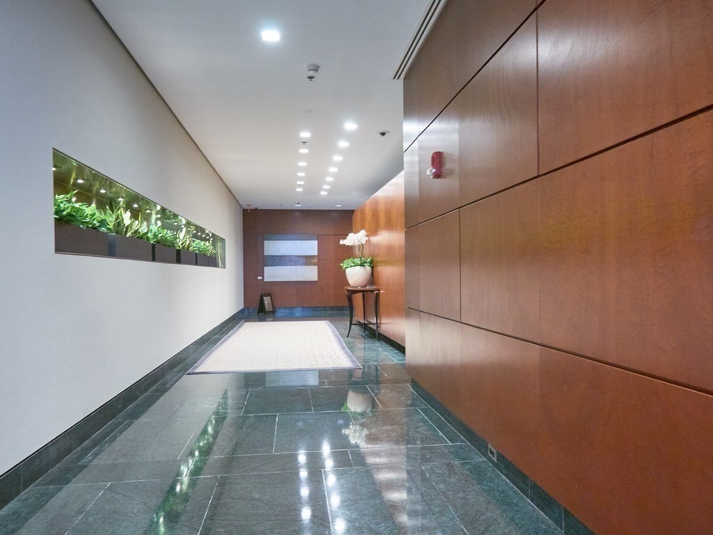 1 Charles Street South, Unit 807 Boston, MA 02116 - Photo 23 of 28 a large room with lots of potted plants in it