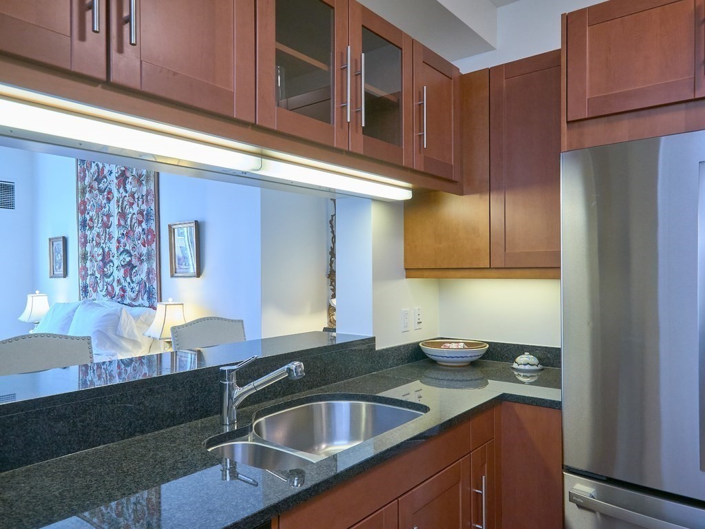 1 Charles Street South, Unit 807 Boston, MA 02116 - Photo 8 of 28 a kitchen with a sink cabinets and a window