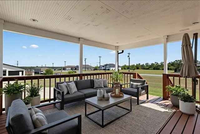 a living room with furniture and view of kitchen