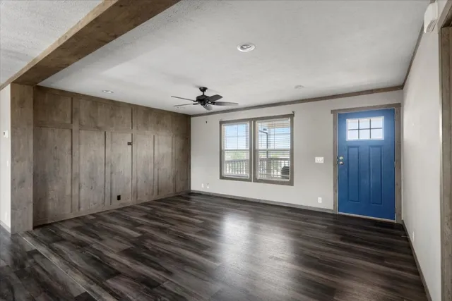 a kitchen with a sink a stove a refrigerator and white cabinets