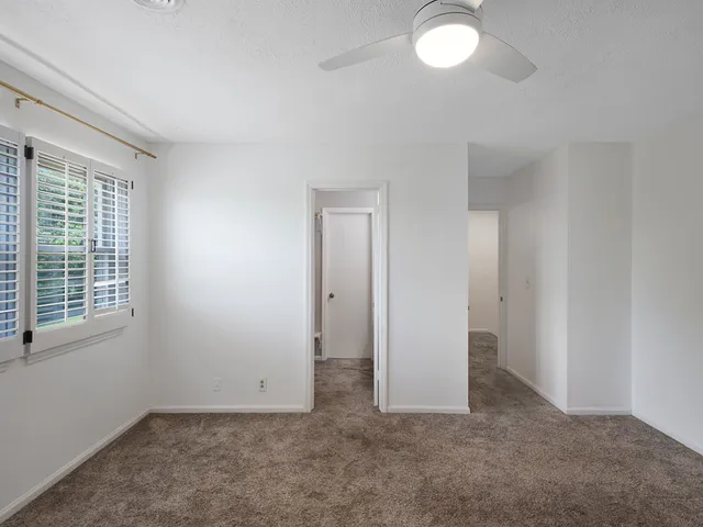 a bathroom with a bathtub shower sink mirror vanity and a toilet