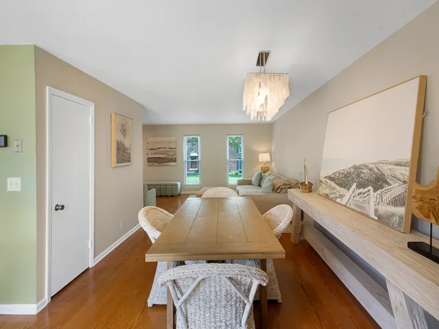 a kitchen with stainless steel appliances a dining table and chairs