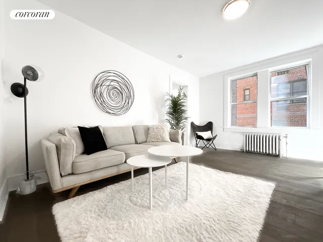 a open kitchen with kitchen island white cabinets and white appliances