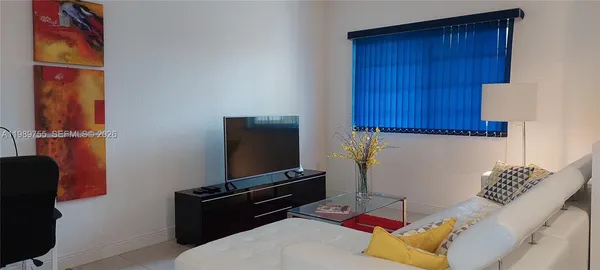 a bedroom with a bed and a chair
