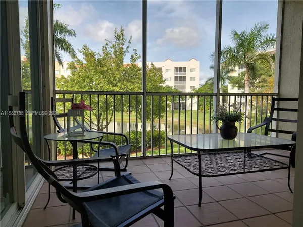 a view of a balcony with wooden floor and outdoor seating
