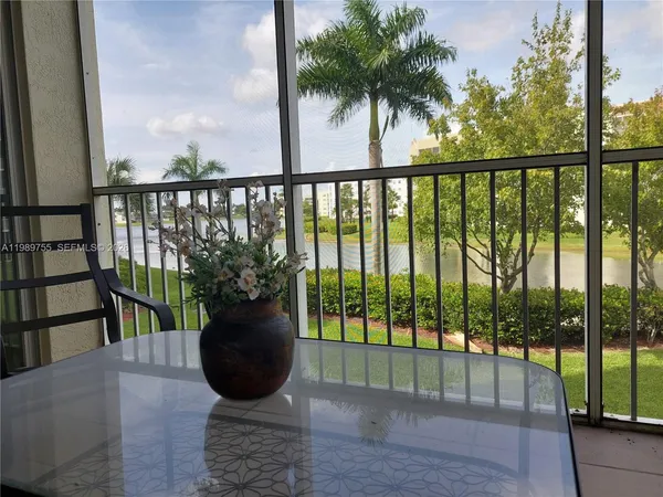 a view of a balcony with potted plants