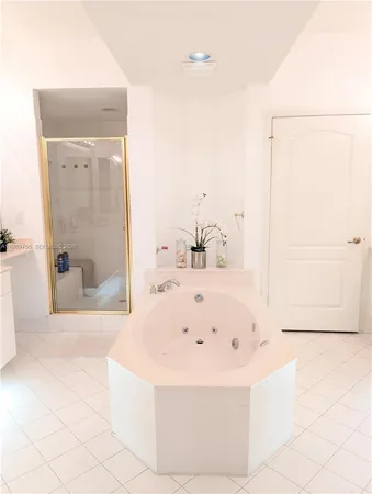 a white bath tub sitting in a bathroom and shower