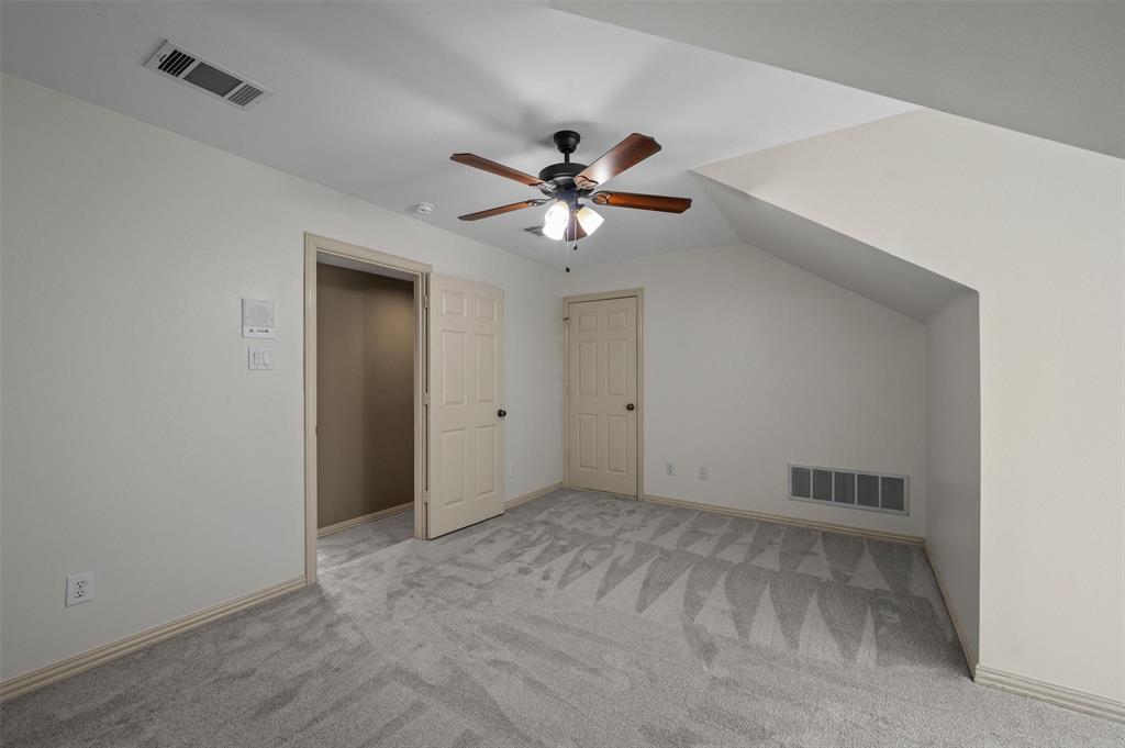 5607 Ranger Drive Rockwall, TX 75032 - Photo 27 of 40 Carpeted room featuring a ceiling fan with light fixture, neutral wall colors, and angled ceilings