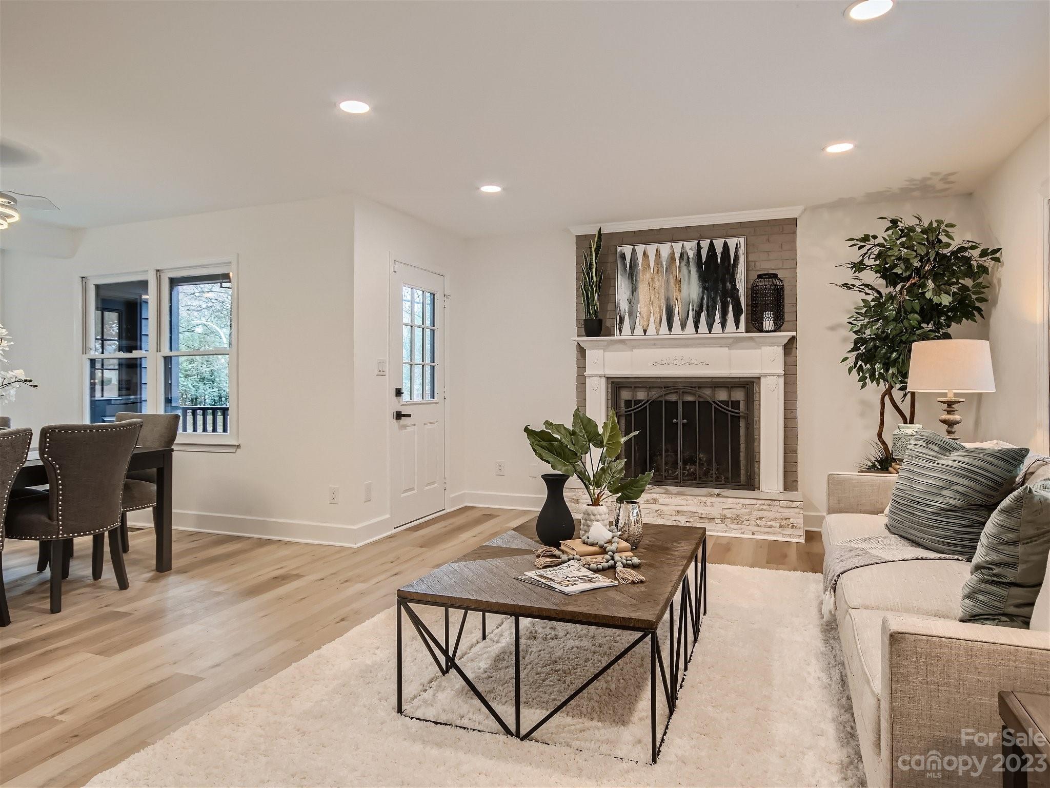 7201 Leaves Lane Charlotte, NC 28213 - Photo 12 of 29 a living room with furniture a fireplace and a potted plant