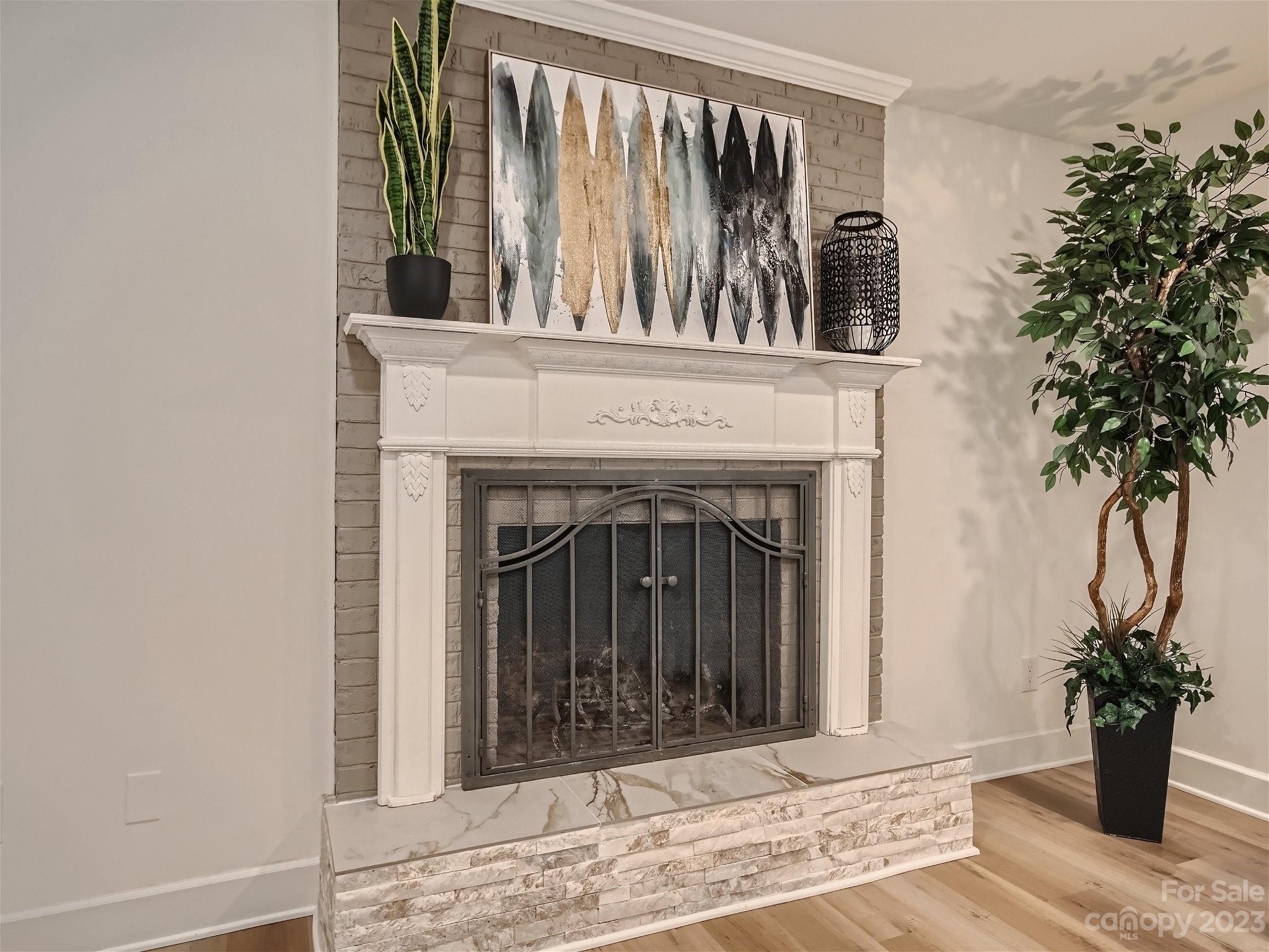 7201 Leaves Lane Charlotte, NC 28213 - Photo 13 of 29 a view of a livingroom with a fireplace and a potted plant