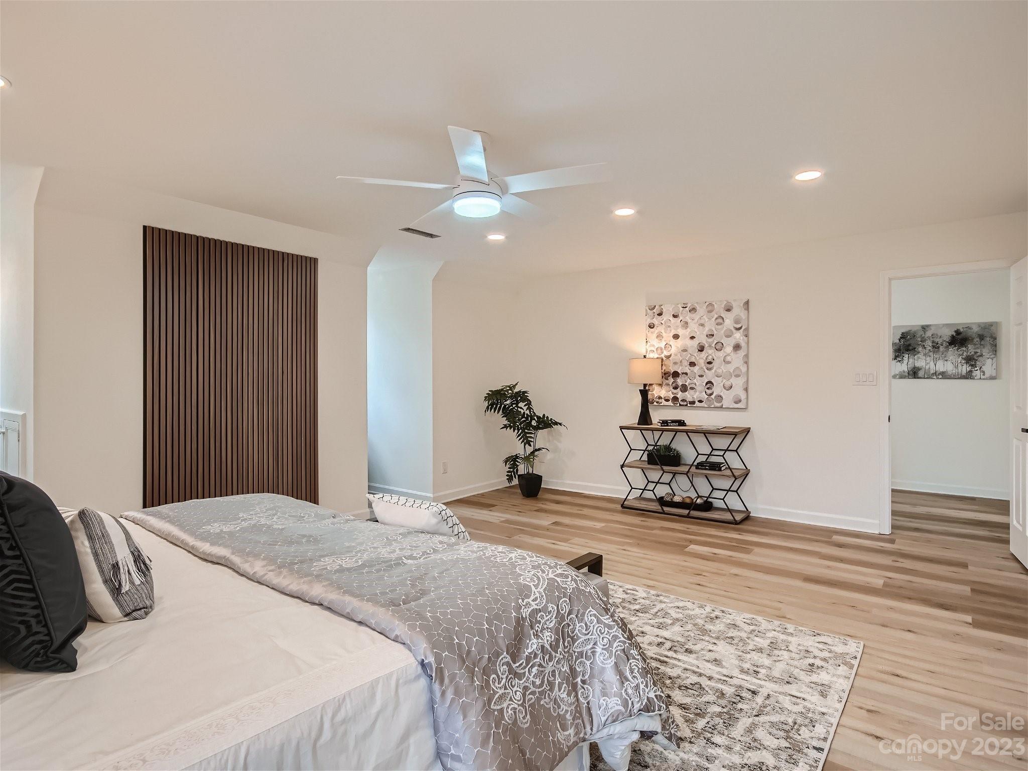 7201 Leaves Lane Charlotte, NC 28213 - Photo 20 of 29 a bedroom with a bed and a chandelier
