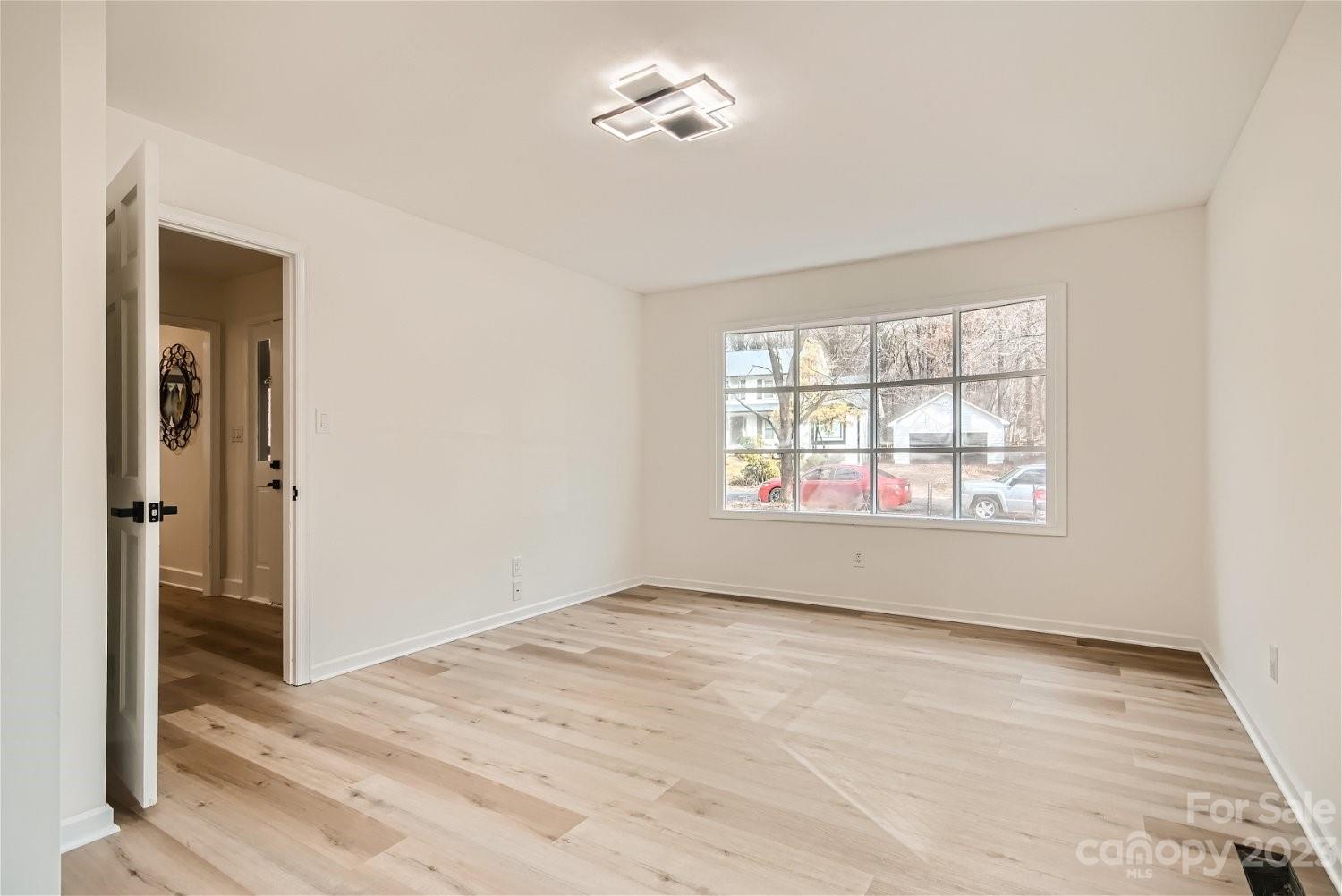 7201 Leaves Lane Charlotte, NC 28213 - Photo 22 of 29 a view of empty room with wooden floor and fan