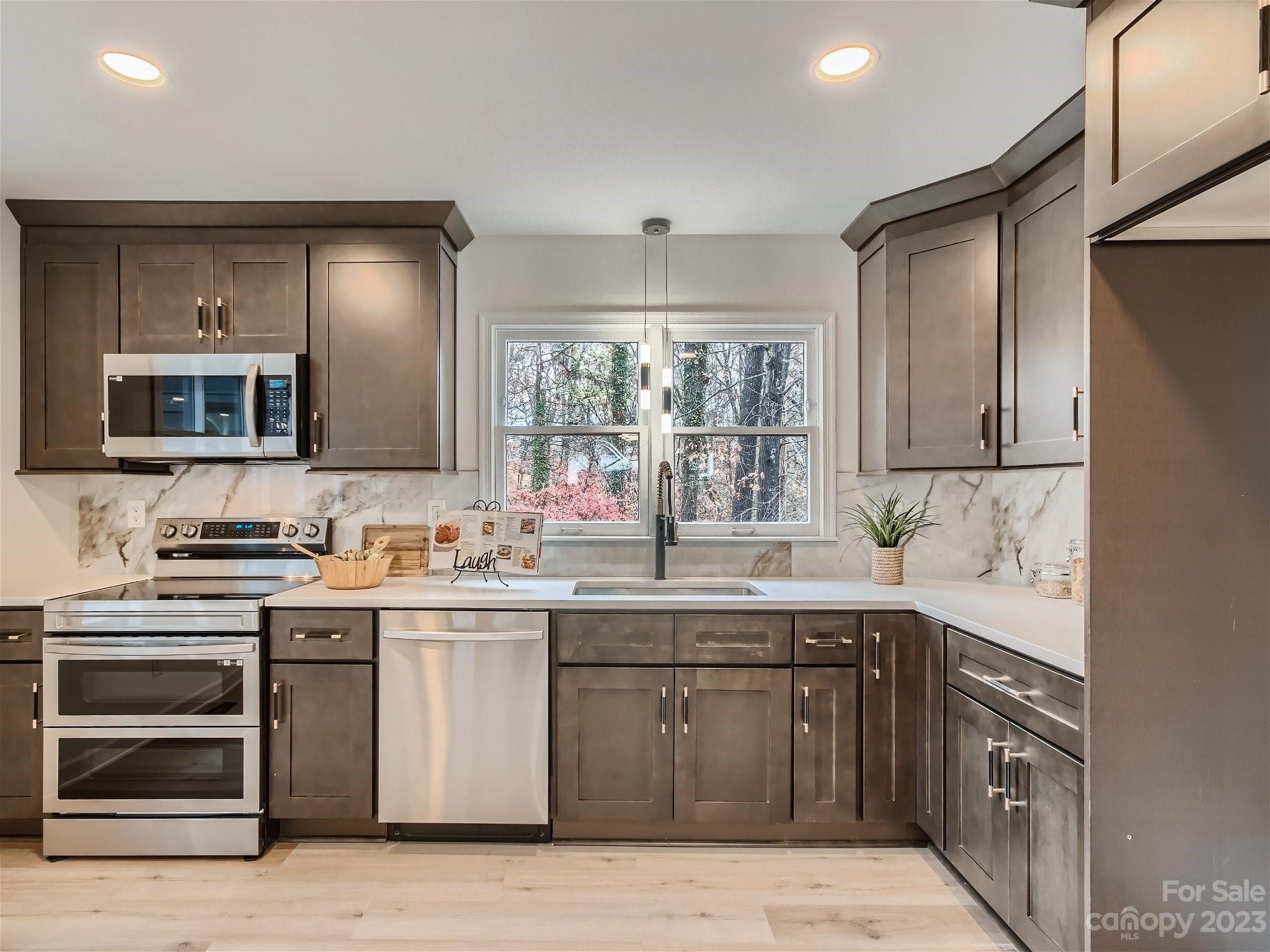 7201 Leaves Lane Charlotte, NC 28213 - Photo 5 of 29 a kitchen with a sink stove and cabinets
