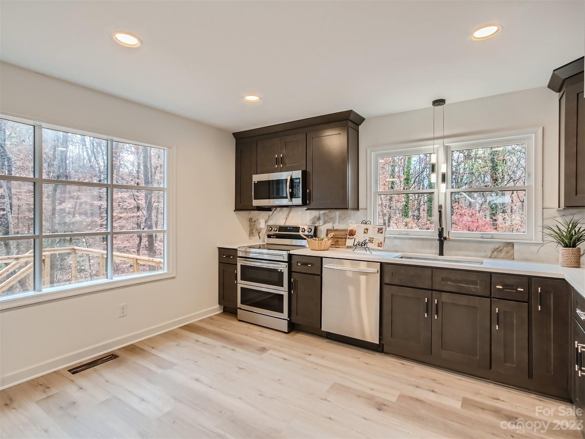 7201 Leaves Lane Charlotte, NC 28213 - Photo 6 of 29 a kitchen with granite countertop a stove a sink and a microwave
