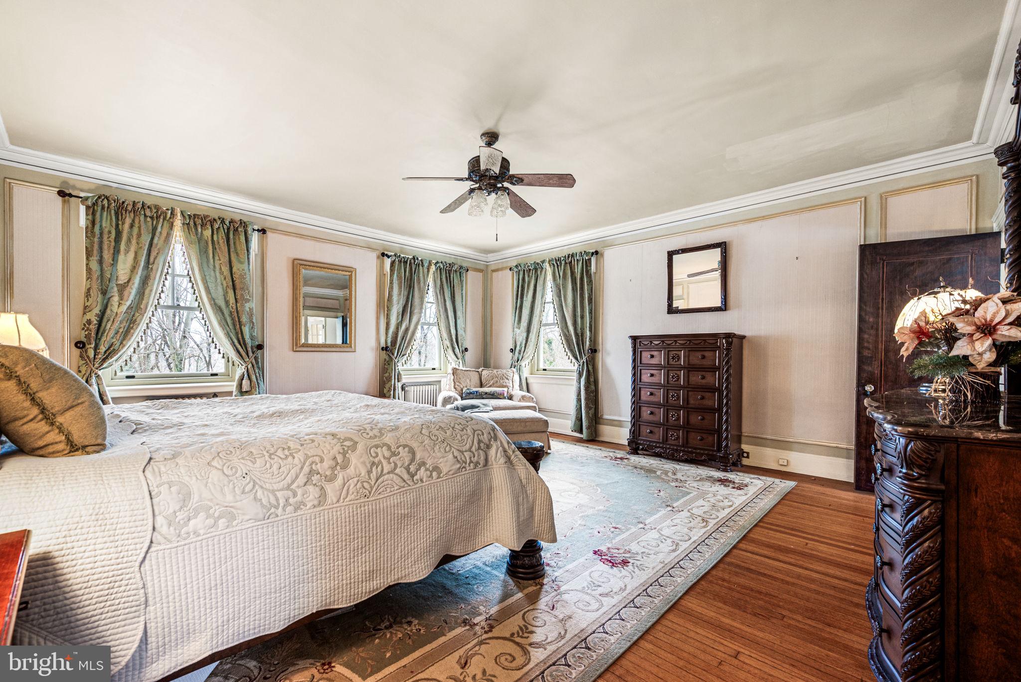1018 Beech Road Wallingford, PA 19086 - Photo 24 of 66 a bed sitting in a spacious bedroom next to a window and a flat screen tv