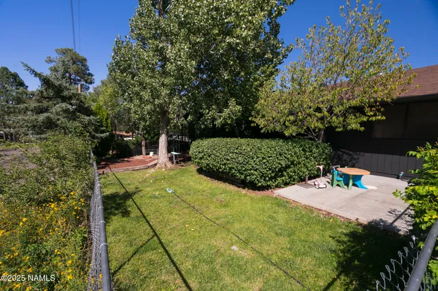 a spacious bedroom with a bed and a chandelier