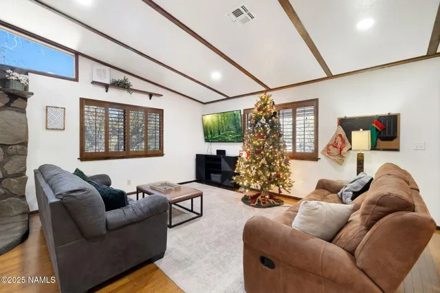 a view of a patio with couches and table and chairs and potted plants