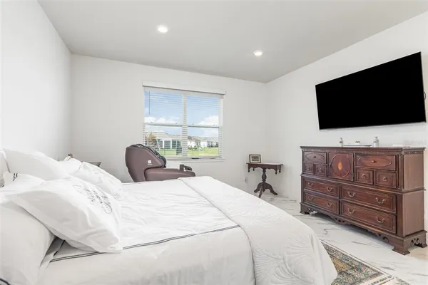 a bedroom with a bed and a flat screen tv