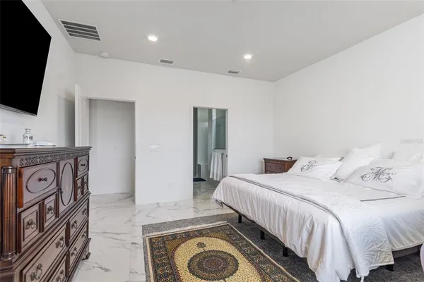 a bedroom with a washing machine and a flat screen tv