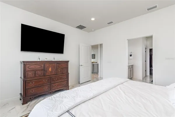 a bedroom with a bed and a flat screen tv