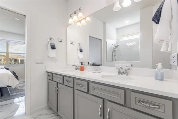 a bathroom with a double vanity sink mirror and