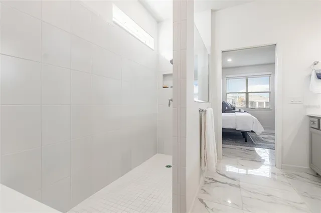 a walk in closet with view of bedroom
