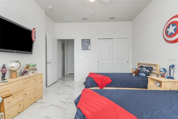 a bedroom with furniture and a flat screen tv