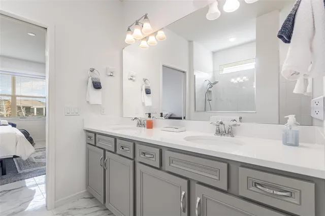 a bathroom with a double vanity sink mirror and