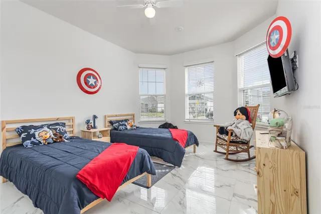 a bedroom with furniture and a flat screen tv