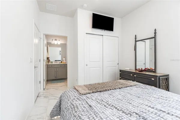 a bedroom with a bed and a flat screen tv