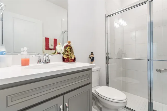 a bathroom with a sink vanity mirror and toilet